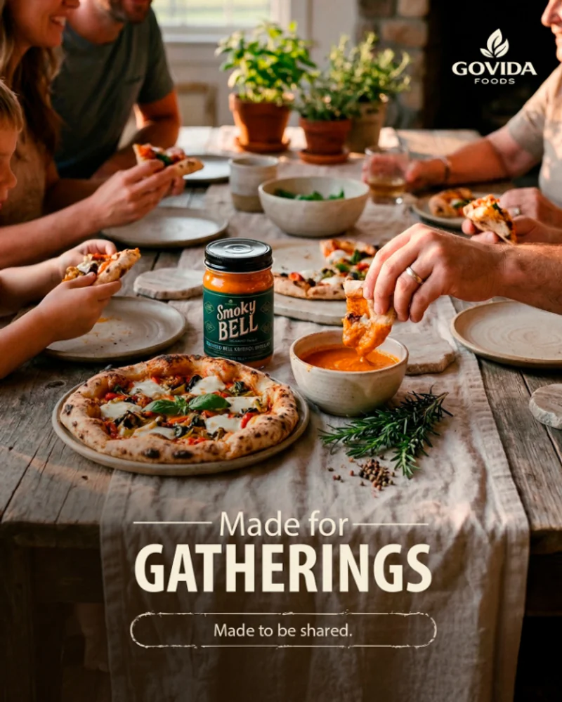 Family and friends sharing pizza with a Smoky Bell jar at the center of the table.